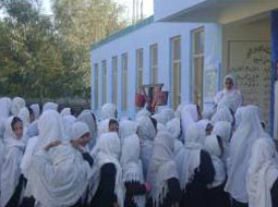 Girl students in front of a new school building